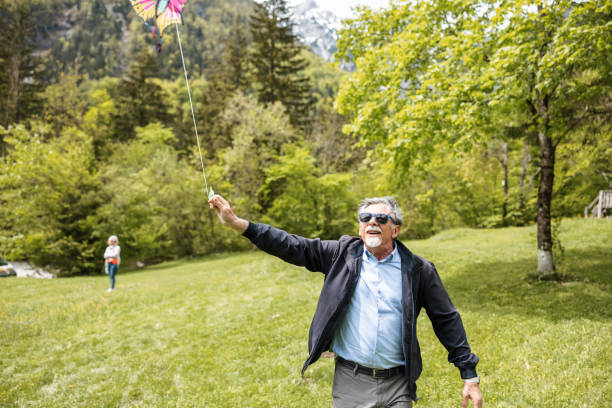 istock Senior Man Flying A Kite Outdoors 1319866839