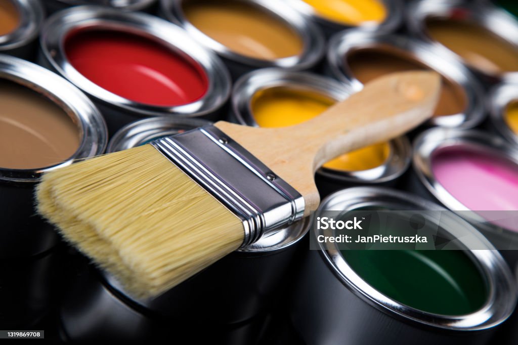 Paintbrush on cans with color Colorful paint cans with paintbrush Art Stock Photo