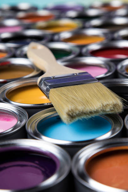 istock Paintbrush on cans with color 1319869759