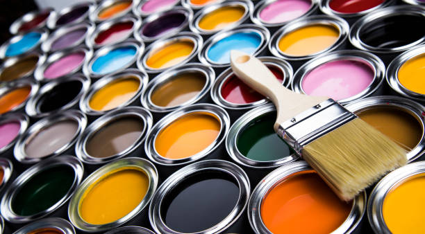 istock Tin metal cans with color paint and paintbrush 1319870848
