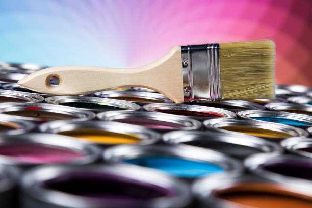 istock Tin metal cans with color paint and paintbrush 1319871469