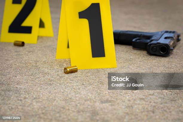 Gun Shell Casing At Crime Scene Gun Violence Mass Shooting And Homicide Investigation Concept Stock Photo - Download Image Now
