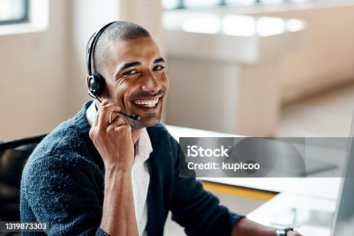 istock Portrait of a young businessman wearing a headset while working in an office 1319873303