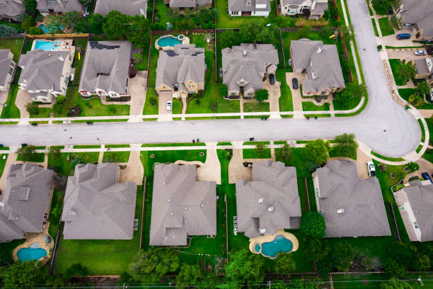 Straight down drone angle above rooftops in Austin Texas never ending suburbs Row after row of thousands of nice large two story houses Aerial Drone view above Luxury living gated community Suburb in Austin Texas USA green summer landscape in Round Rock , TX luxury gated community stock pictures, royalty-free photos & images