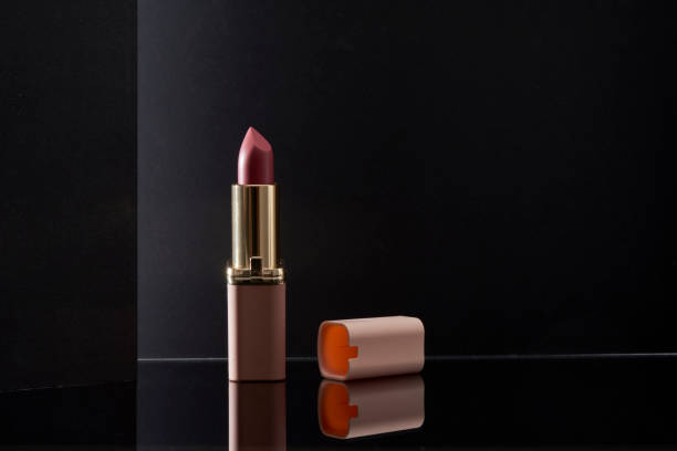 istock Pink lipstick with an artistic black background 1319881079