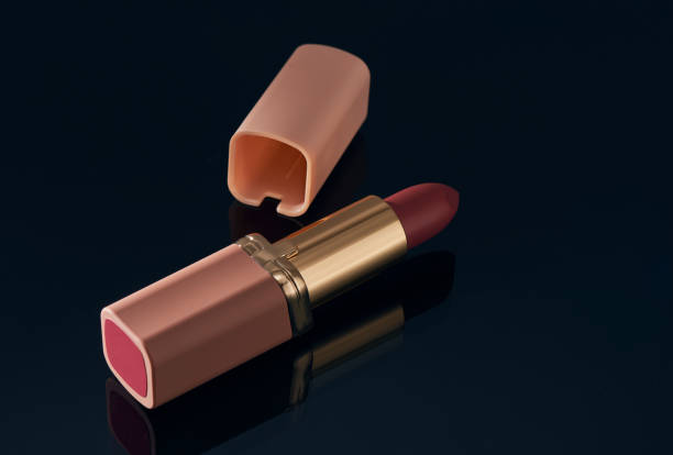 istock Pink lipstick on a smoky blue glass surface, with corner space for text 1319881083