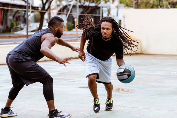 istock Young man approaches to steal opponent's ball 1319882465