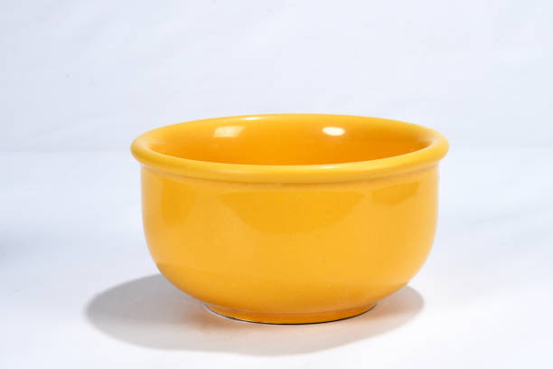 istock yellow bowl isolated on white background with space for text 1319882544