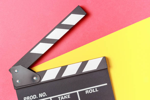 istock The clapperboard on yellow and red background close-up top view. 1319885696