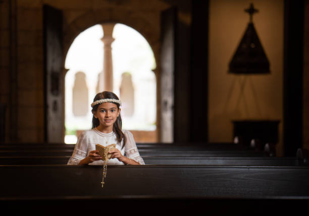 First Communion hispanic girl praying