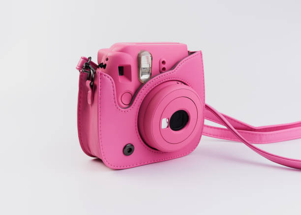 istock Pink instant photography camera on a white background 1319888945