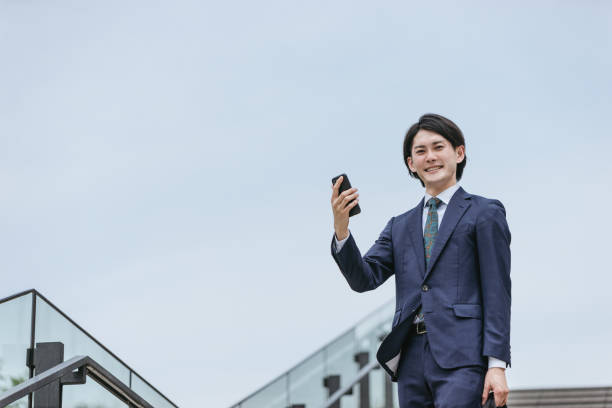 istock Image of IoT | A man who operates home appliances from his commute 1319889547