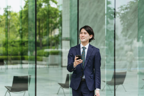istock Young men coming to work ・ IoT / business image with smartphones 1319889650