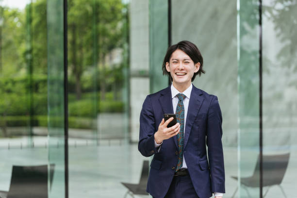 istock Young men coming to work ・ IoT / business image with smartphones 1319889675