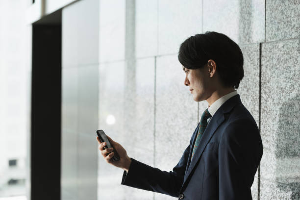 istock Image of young man with smartphone, IoT and business (backlight, profile, silhouette) 1319889761