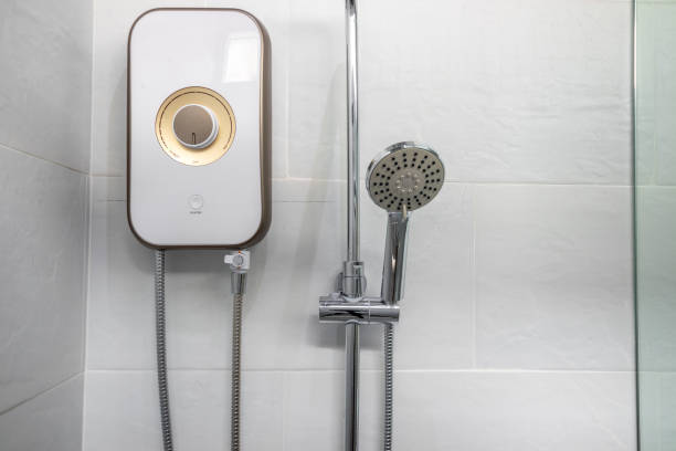 istock Shower and water heater in a white bathroom. 1319894568