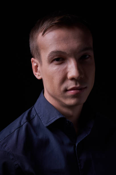 istock Beautiful young guy on a black background in the Studio 1319898590