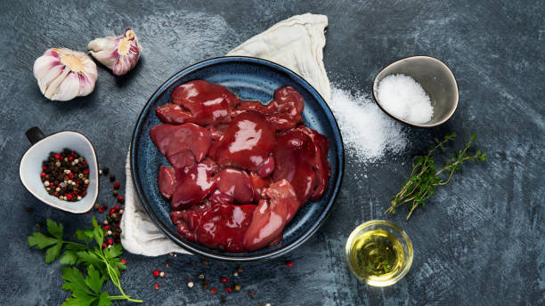 Chicken meat Raw uncooked liver with spices and herbs prepared for cooking on gray background. Top view, copy space, panorama animal liver stock pictures, royalty-free photos & images