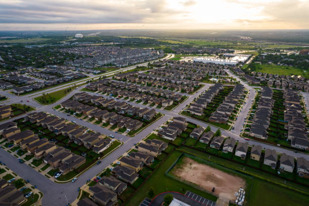 istock Suburb houses along green landscape ar sunset 1319904001