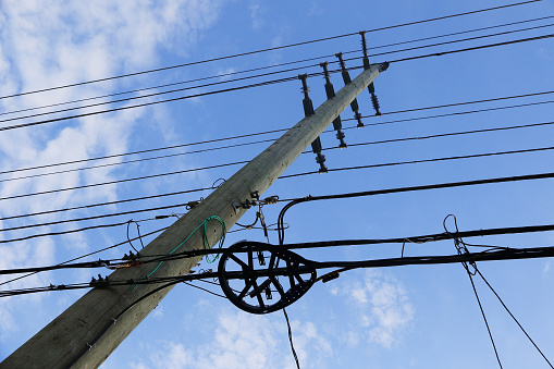 Modern electrical wires on a hydro pole, with newer fiber optic service loop visible in the foreground