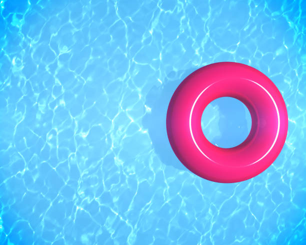 istock Summer time background with pink inflatable ring donut float in blue swimming pool and copy space for text, 3d rendering 1319905461