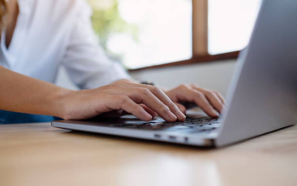 istock a woman working and typing on laptop computer keyboard on the table 1319906462