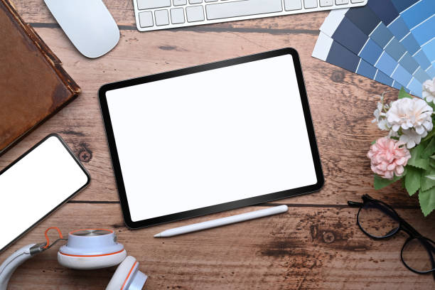 istock Above view mock up digital tablet, stylus pen, heaping and mobile phone on graphic designer workspace. 1319910427
