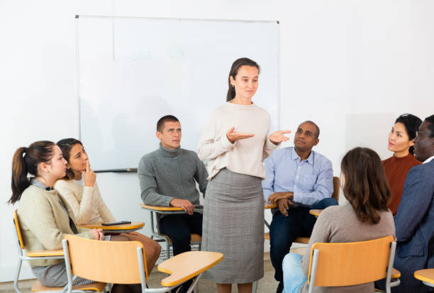 istock Woman addressing multi-cultural office staff meeting 1319914564
