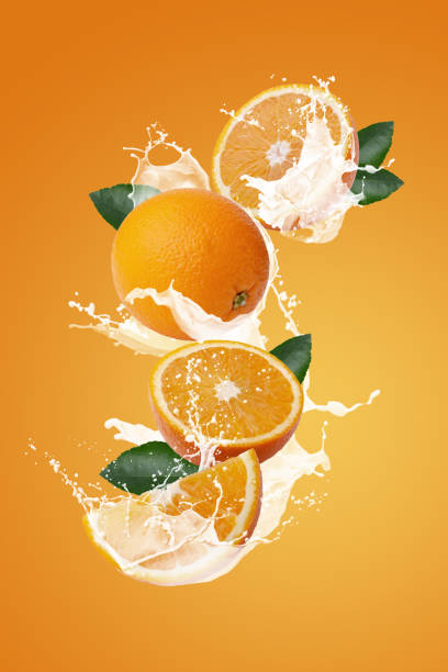 Milk Splashing on Orange Fruit and Orage Slice isolated on a orange background