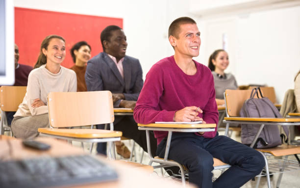 istock Attentive students at their desks in university auditorium 1319914614