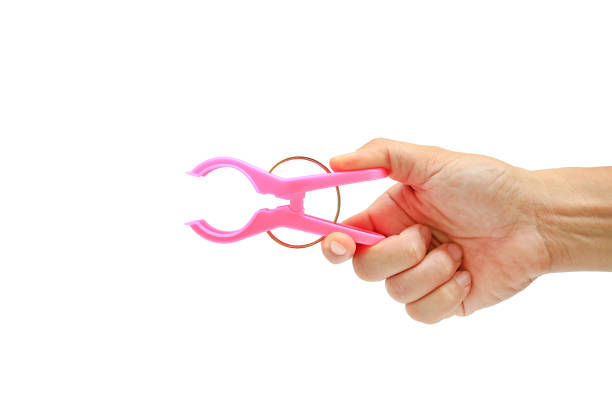 istock Clothespin in hand holding isolated on white background - clipping path 1319918065