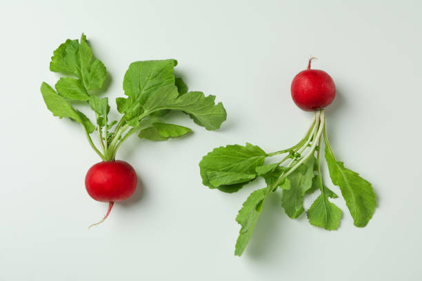 istock Two fresh radishes on white background, close up 1319918926