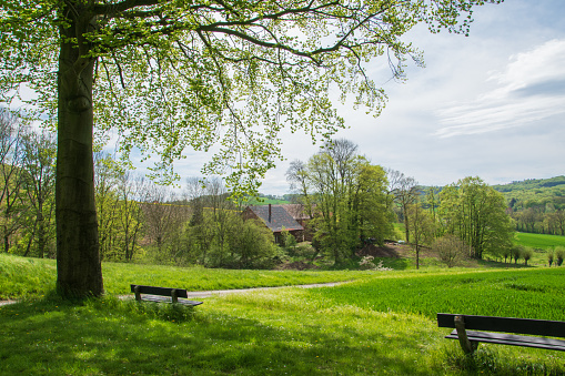 View over the Lippe hill country near Bad Senkelteich in East Westphalia. Two benches in the foreground.
