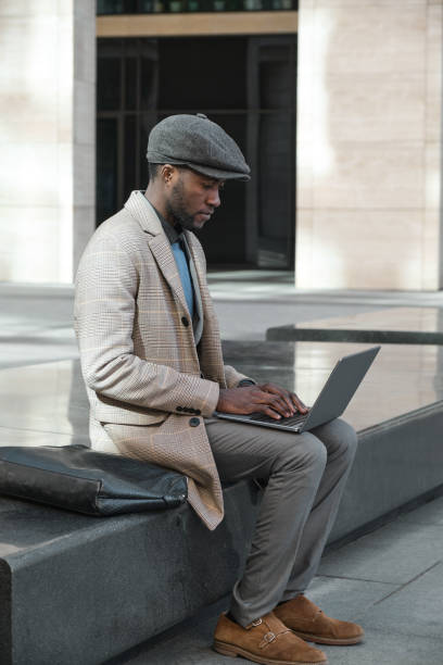 istock Man working on laptop outdoors 1319920624