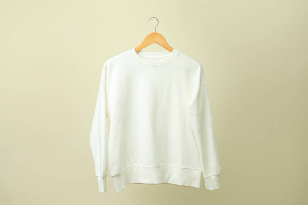 istock Hanger with white sweatshirt against beige background 1319921217