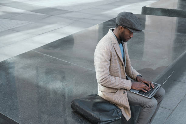 istock African man using laptop in the city 1319921413