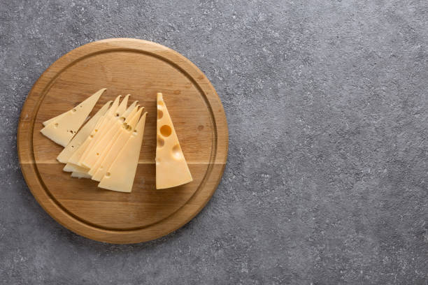 istock Piece of cheese and slices on a kitchen board close up 1319922192