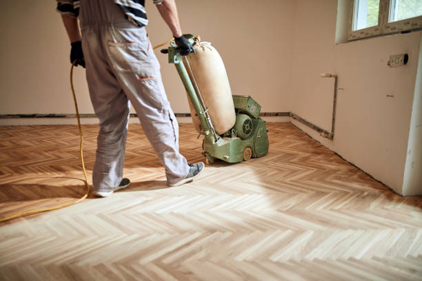 istock Repairman restoring parquet with a sanding machine. 1319922396