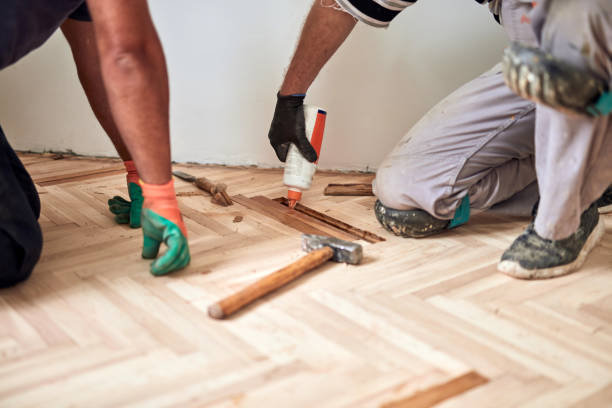 istock Repairman restoring parquet with a sanding machine. 1319922925