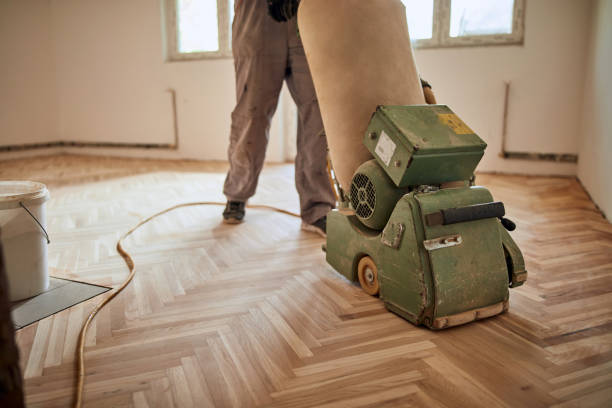 istock Repairman restoring parquet with a sanding machine. 1319922956