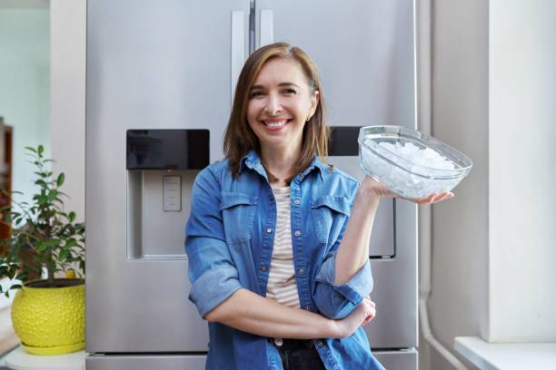 istock Woman with bowl with ice cubes for cooling food 1319922980