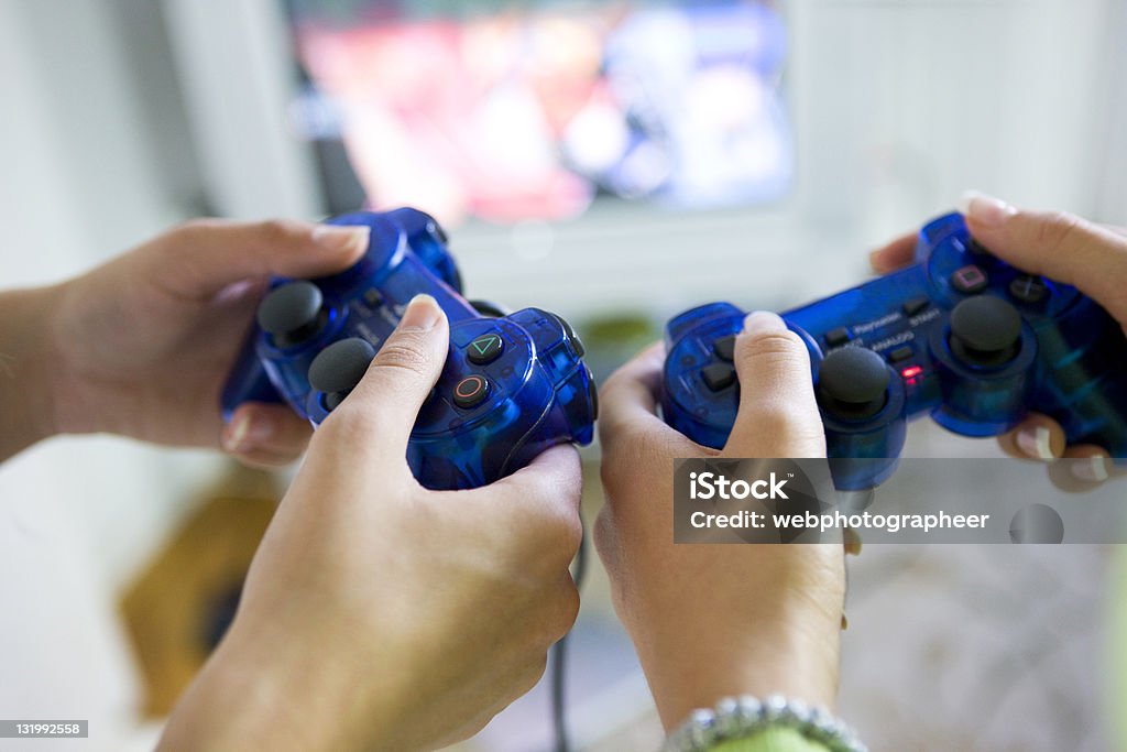 Playing video game Two women  playing video game, selective focus, canon 1Ds mark III Playing Stock Photo