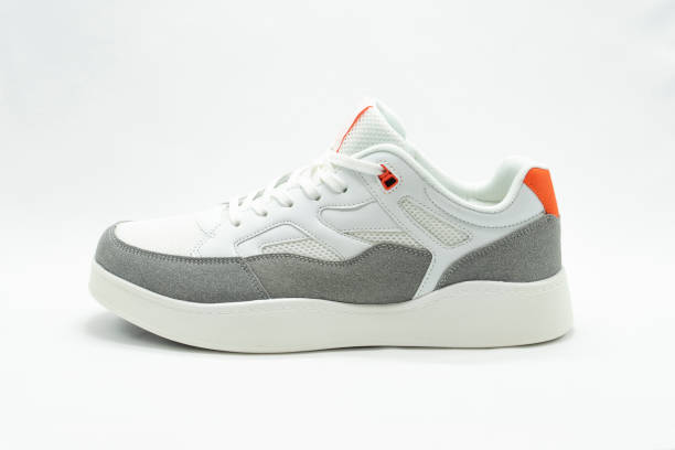 istock White running shoe with orange inserts on a white isolated background with space for copying text 1319925910