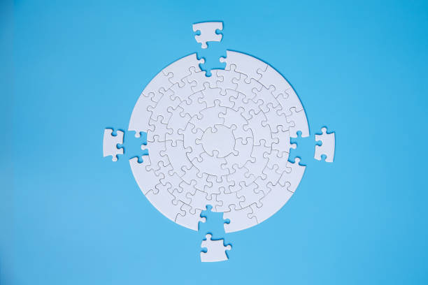 istock White jigsaw puzzle pieces on a blue background. Problem solving concepts. Texture photo with copy space for text 1319926188
