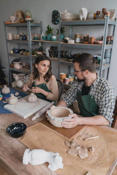 istock Man and woman ceramist working together in their studio 1319926302