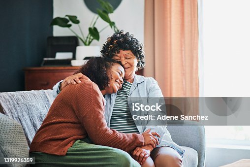 istock Shot of an elderly woman relaxing with her daughter on the sofa at home 1319926359