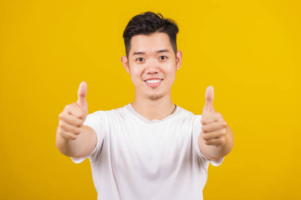 istock man smiling positive showing thumbs up gesture 1319927462