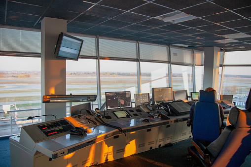 Dispatcher background. The workplace of the traffic manager at the airport at the tower. Chair, table, monitors, screens and equipment. Air traffic controller work