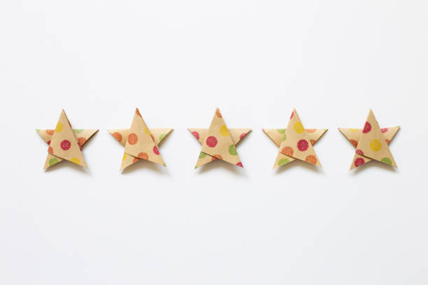 istock Colorful dot pattern brown five stars quality rating on white background. top view 1319928388