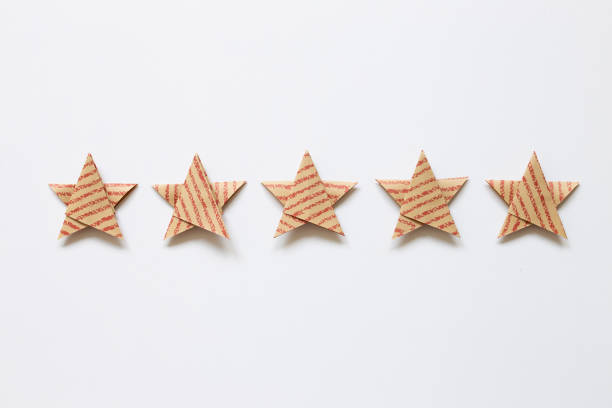 istock Red stripe pattern brown five stars quality rating on white background. top view 1319928595
